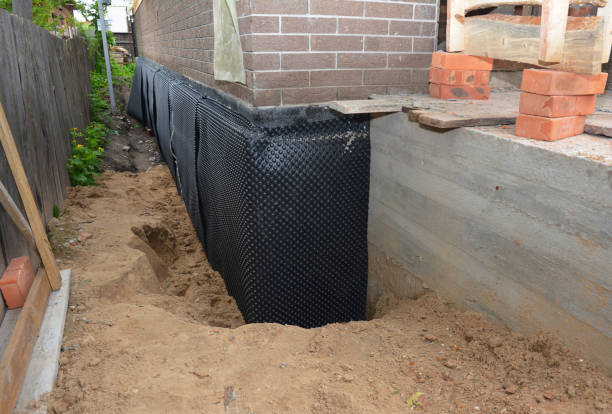 Happy homeowners after waterproofing job in Leonard